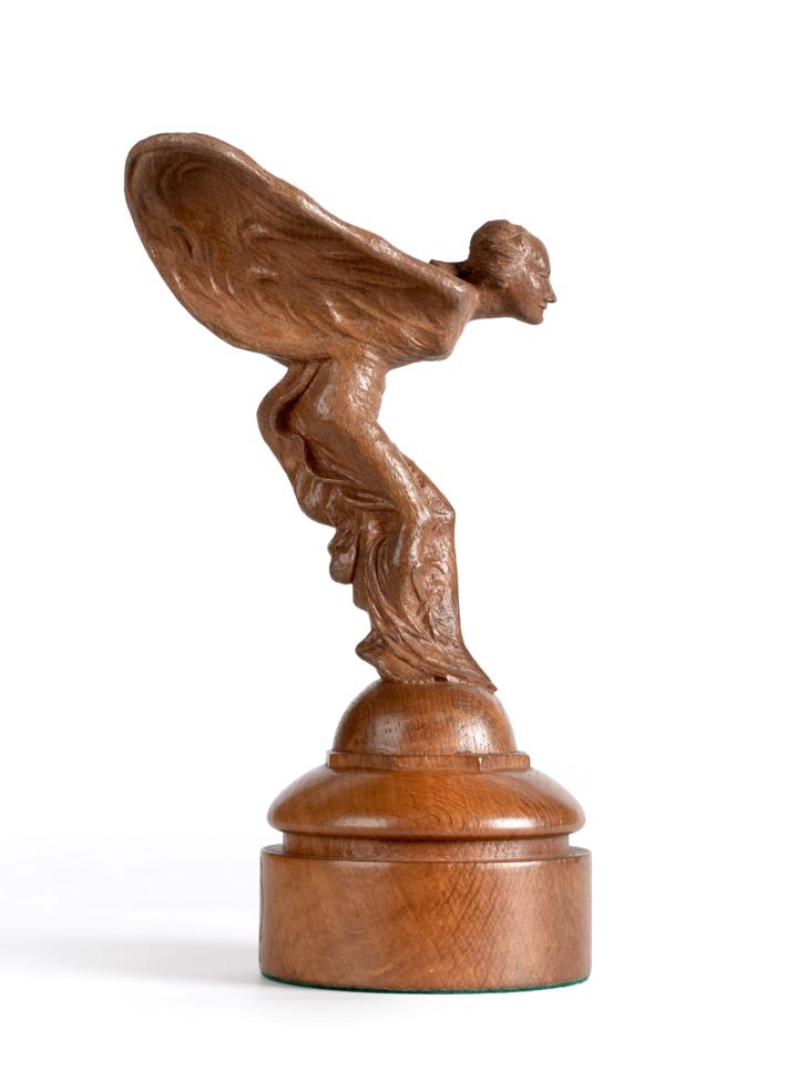 Lot 703 - Stan  "Woodpecker " Dodds (1928-2012): A Carved Oak Spirit of Ecstasy, on a circular base, with...