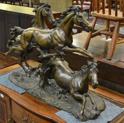 Lot 1338 - A modern bronze group of three horses