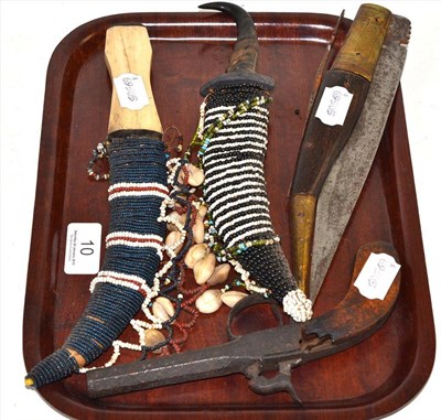 Lot 10 - An Arab folding knife, two African knives with beaded sheaths and a percussion pocket pistol