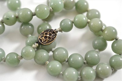 Lot 77 - A jade type bead necklace with silver clasp