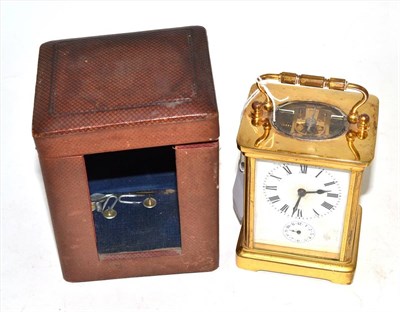 Lot 97 - A French brass alarm carriage clock with key and case