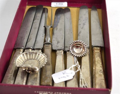 Lot 139 - A set of seven Holy Steel knives, one matching fork, scrolled salt inset with a coin and a spoon