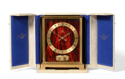 Lot 737 - A Brass Atmos Clock, signed Jaeger LeCoultre, model: Embassy Red, circa 1969, case with red...