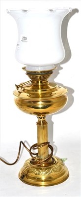 Lot 255 - A brass oil lamp fitted for electricity, with shade