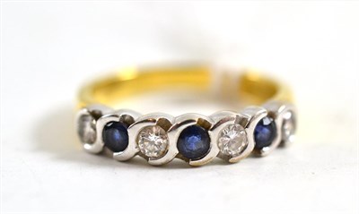 Lot 320 - An 18ct gold sapphire and diamond half eternity ring, round brilliant cut diamonds alternate...