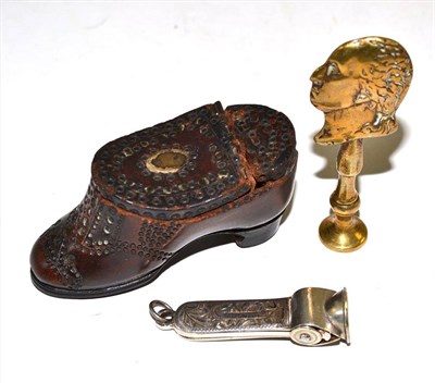 Lot 324 - An 18th century brass pipe tamper, the handle modelled as a profile bust (possibly George...