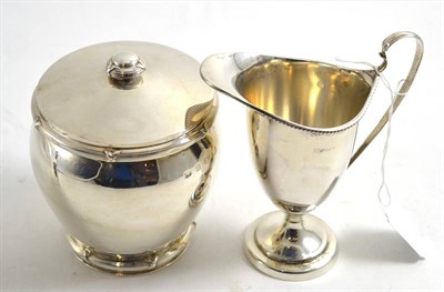 Lot 333 - A silver jar and cover, together with a silver helmet jug