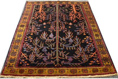 Lot 757 - Unusual Nahavand Rug West Iran, circa 1930 The midnight blue field with Tree of Life surrounded...