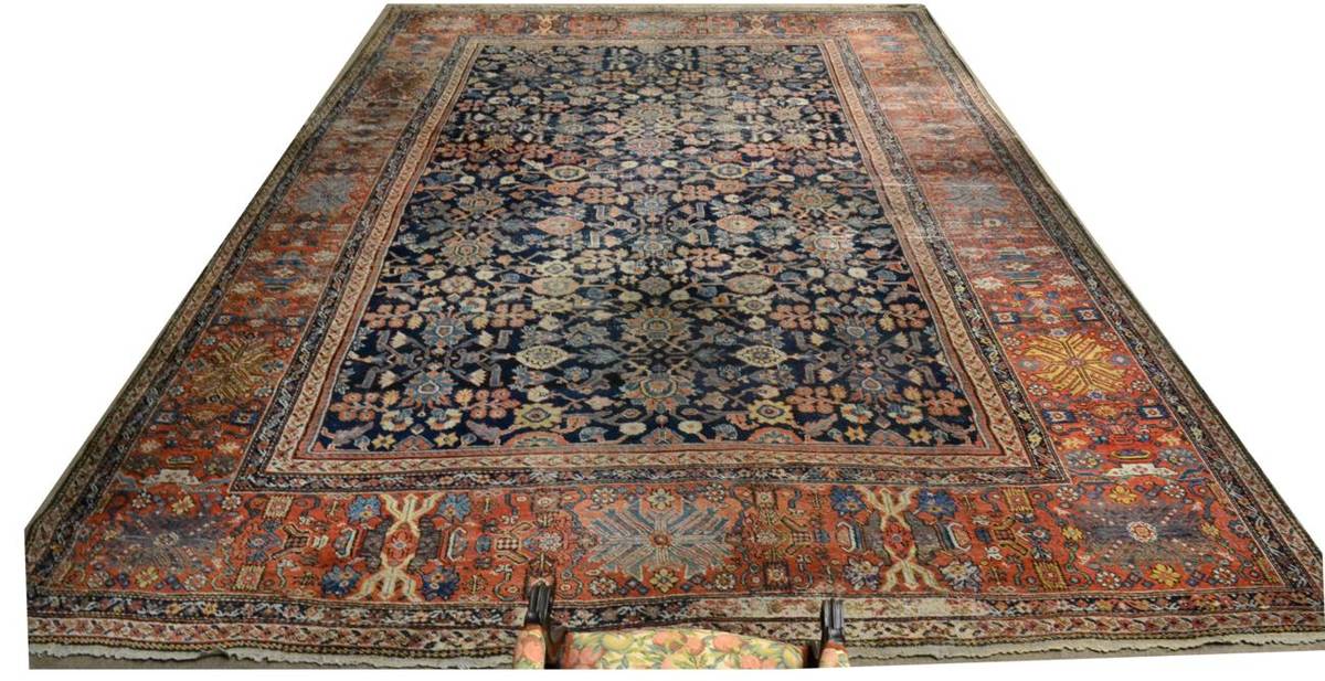 Lot 758 - Large Feraghan Carpet West Iran, circa 1860 The indigo field with an allover design of plants...
