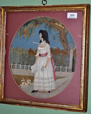 Lot 384 - Early 19th century felt applique and wool embroidered picture, depicting a young girl in a...