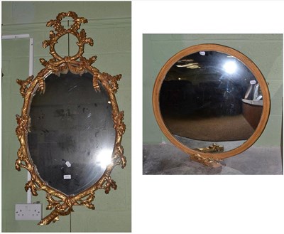 Lot 411 - An oval gilt and gesso wall mirror and a convex wall mirror