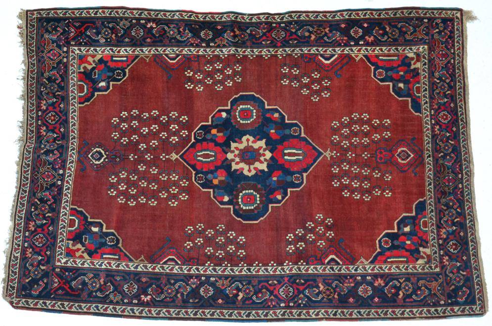 Lot 764 - Karabagh Rug South Caucasus, circa 1900 The chestnut field with urns issuing flowers around an...
