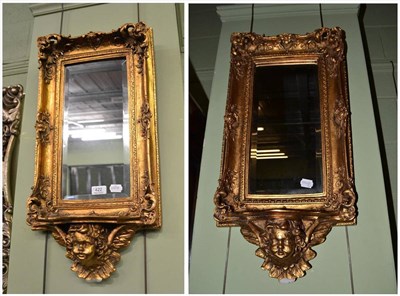 Lot 422 - Pair of modern gilt framed wall mirrors with cherubs