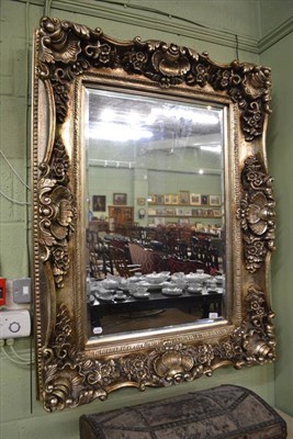 Lot 423 - A silvered heavily embossed modern wall mirror