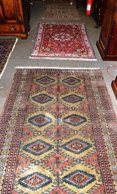 Lot 426 - Bukhara rug, Lahore, Punjab, the deep camel field with columns of stepped medallions enclosed...