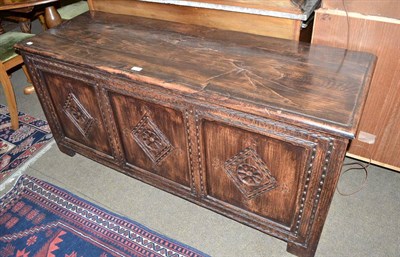 Lot 447 - Reproduction oak blanket chest with carved panel