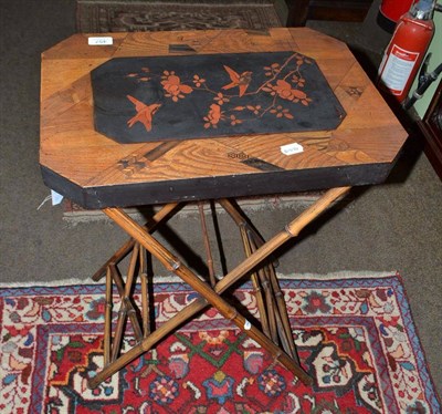 Lot 457 - A lacquered and inlaid Chinese occasional table on folding bamboo stand