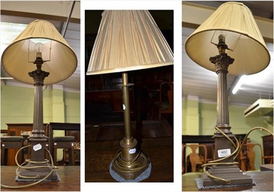 Lot 460 - Pair of modern Corinthian style table lamps with cream shades and a gilt metal lamp and shade (3)