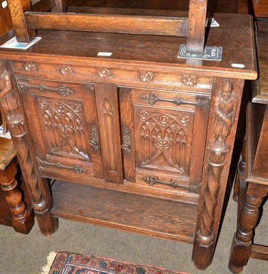 Lot 461 - Reproduction oak two door small cabinet carved with knights