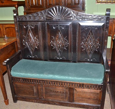 Lot 473 - Dark oak settle with carved back