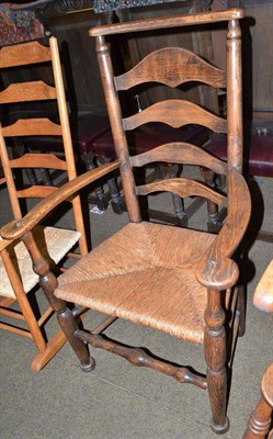 Lot 478 - A rush seated ladder back armchair