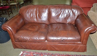 Lot 488 - Laura Ashley brown leather two-seater settee with original labels