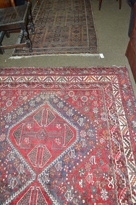 Lot 489 - Kashgai rug, South West Persia, the claret field of tribal motifs around two stepped medallions...