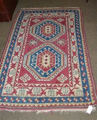 Lot 490 - Kars rug, East Anatolia, the raspberry field with two octagons enclosed by triple ivory...