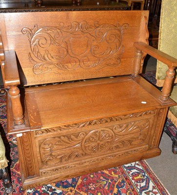 Lot 504 - Carved oak monks bench