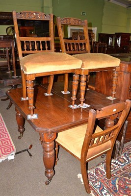 Lot 507 - A late Victorian walnut wind-action dining table with canted ends, together with four late...