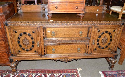 Lot 510 - An early 20th century heavy oak sideboard, with low raised back, fine fret cut decoration,...