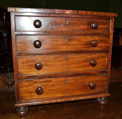 Lot 511 - Mahogany table top four drawer chest