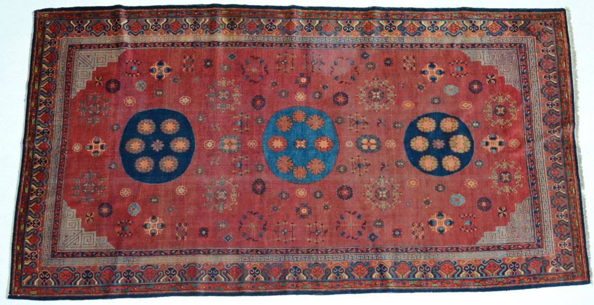 Lot 776 - Khotan Carpet  East Turkestan, circa 1900 The terracotta field sparsely decorated with...