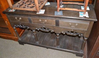 Lot 523 - Reproduction dark oak sideboard with carved frieze