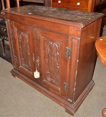 Lot 524 - Italian carved walnut double door cabinet with carved panels