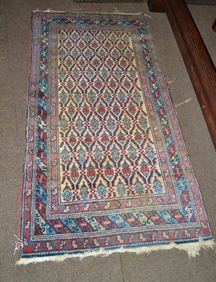 Lot 529 - Erivan rug, South Caucasus, the ivory serrated lattice field enclosing stylised flowers framed...