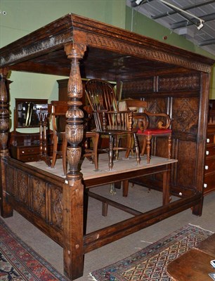 Lot 530 - Reproduction oak four poster bed with carved back panel and posts