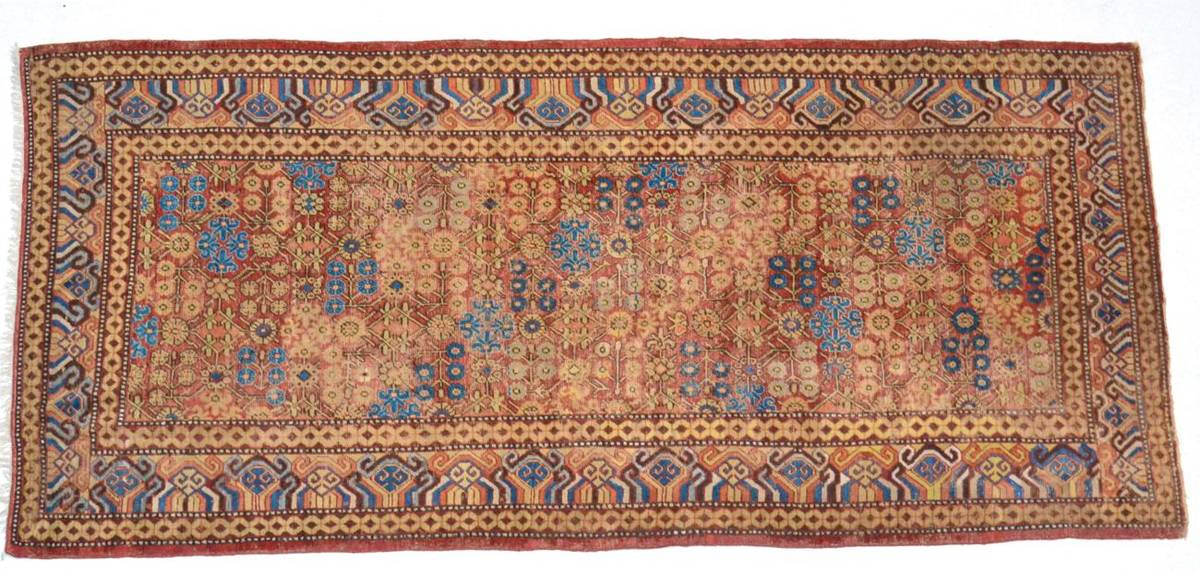Lot 777 - Khotan Carpet  East Turkestan, circa 1900 The terracotta field with a lattice of flowering...