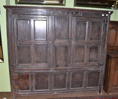 Lot 542 - A joined oak cupboard, carved initials and dated RTA 1694, with two fielded cupboard doors,...