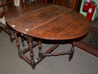 Lot 548 - An 18th century drop leaf oak dining table