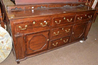 Lot 550 - George III oak and mahogany cross banded dresser base with five drawers and two cupboard doors