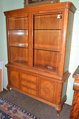 Lot 555 - A European walnut, satinwood and maple display cabinet