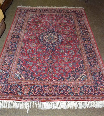 Lot 558 - Kashan rug, Central Persia, the raspberry field of palmettes and vines around an indigo pole...