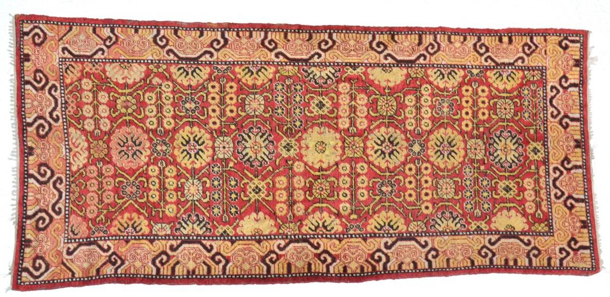 Lot 781 - Khotan Rug East Turkestan, early 20th century The madder field centred by a column of...
