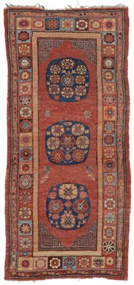 Lot 783 - Khotan Rug East Turkestan, 19th century The brick red field with three indigo roundel...