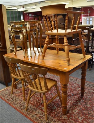 Lot 593 - A modern pine plate rack, a pine kitchen table, four pine chairs, pink ground rug and a nest of...