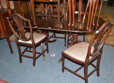 Lot 597 - Reproduction mahogany twin pedestal dining table, set of four shield back dining chairs and...