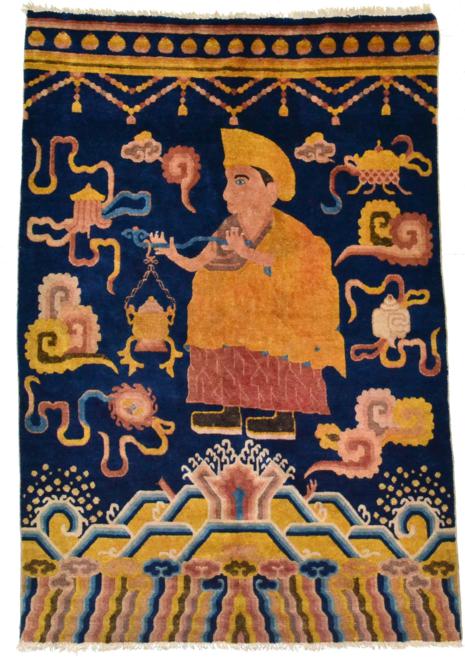 Lot 784 - Ningxia or Tibetan Temple Rug The indigo field depicting a Monk with sensor surrounded by...