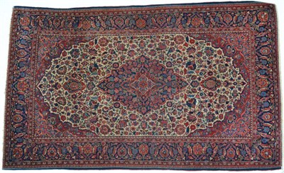 Lot 790 - Kashan Rug Central Iran, circa 1930 The ivory field of flowering vines around an indigo pole...