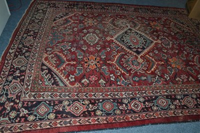 Lot 652 - Mahal carpet, West Persia, the raspberry field of large stylised flowerheads around a cusped...